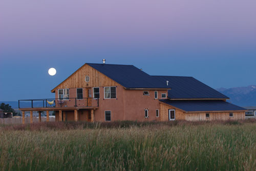 “The view is so open,” says Emmanuelle Vital of the straw bale house set on eight acres of open plains. “On a full moon, you can go out on the deck, and it feels like you have the light on.”